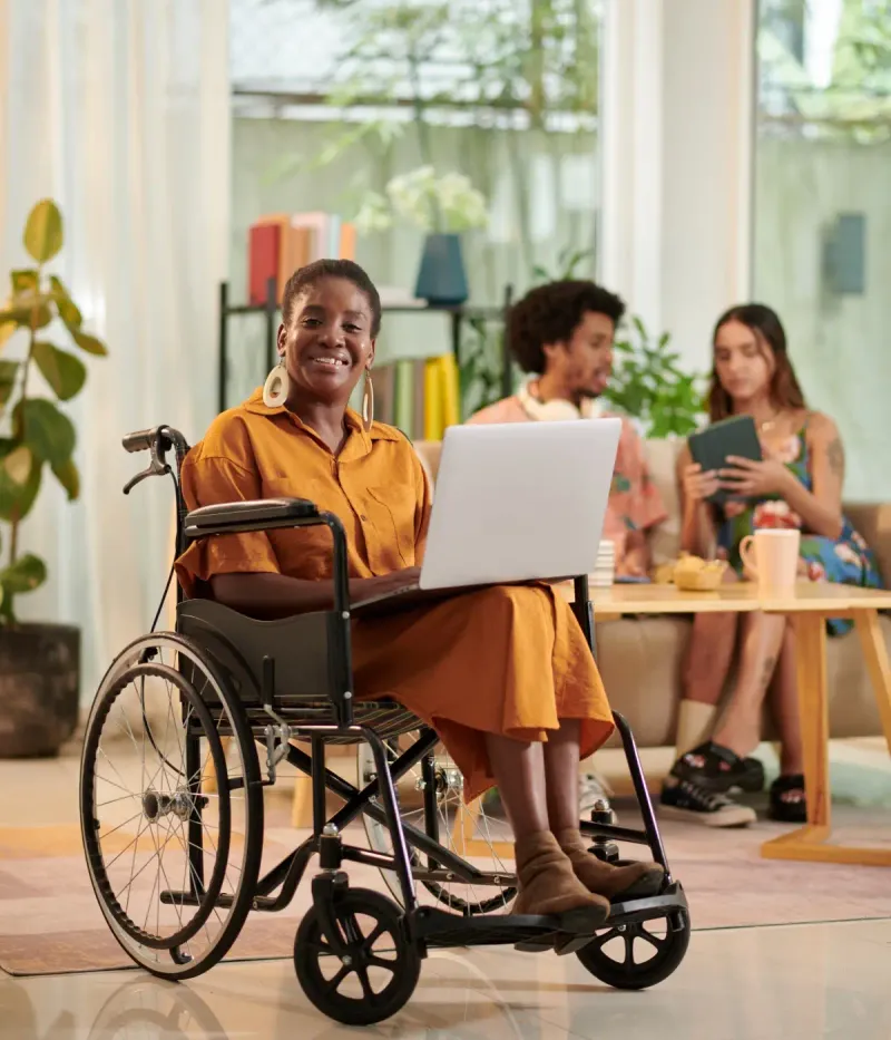 Professional Support Services & Solutions team member smiling while using a laptop